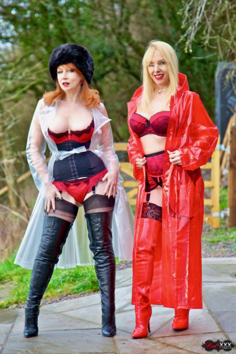 British lesbians expose boobies while modelling raincoats and thigh-high boots - #257041