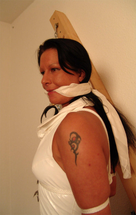 Brunette skank girl is cleave gagged and restrained to a St Andrew's Cross in boots - #170504