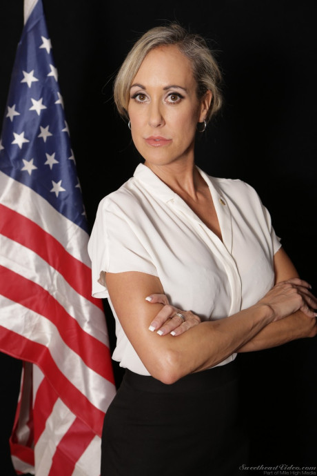 MILF Julia Ann stripping down nude on the couch and showing her fake titties - #194169