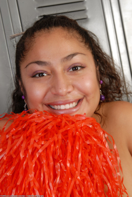 Thin curly haired cheerleader Reena shows her wide booty and bushy pussy