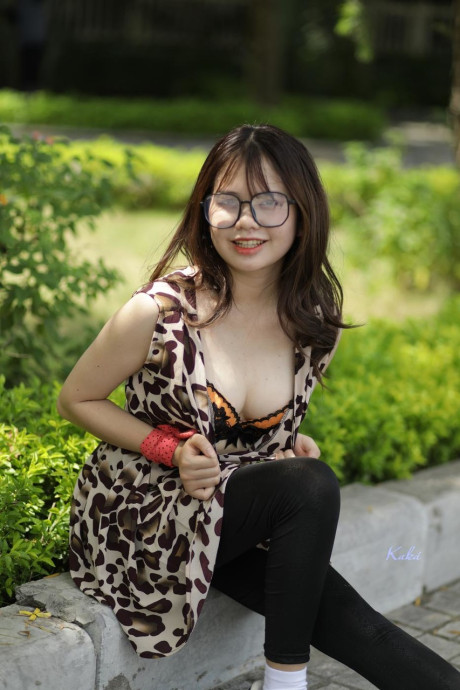 Sweet solo whore gf girl displays her cleavage while seated on a curb in the outdoors - #296497