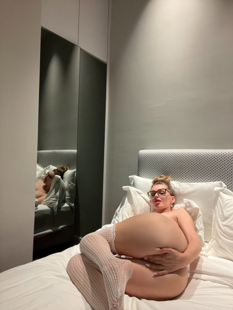 Long legged hottie models naked on a bed in glasses and over the knee socks - #313734