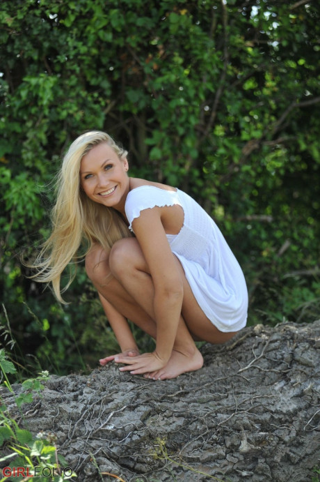 Blonde whore GF chick Michaela shows her bareback ass after getting undressed in a field - #199603