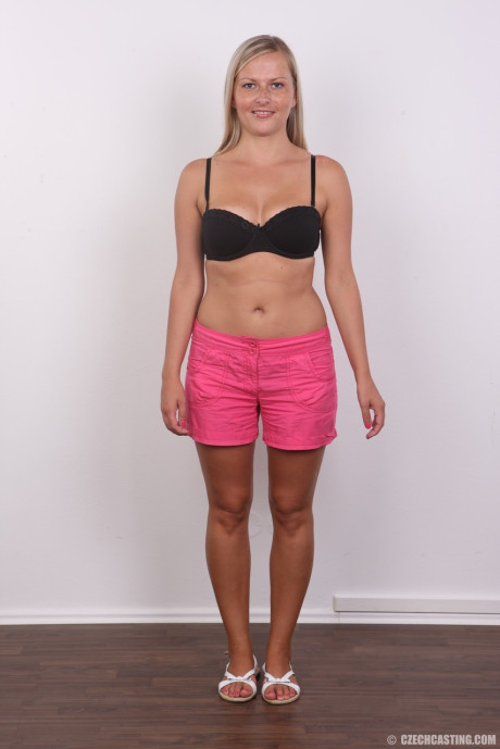 Amateur blondy Petra doffs her black bra and panties for a naked mugshot