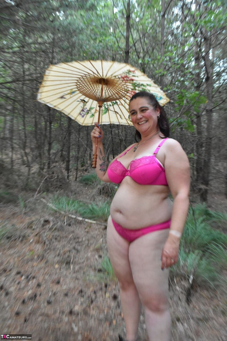 Old BBW removes a dress before uncovering her natural breasts in the woods - #294079
