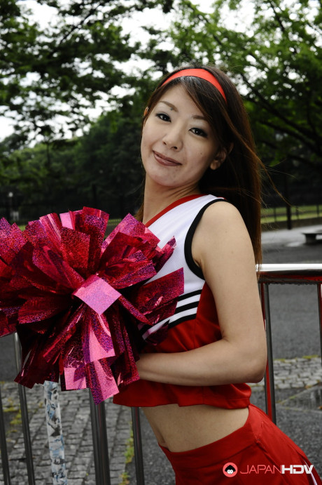 Japanese cheerleader Tomomi Matsuda gives a demonstration at a playground - #190894