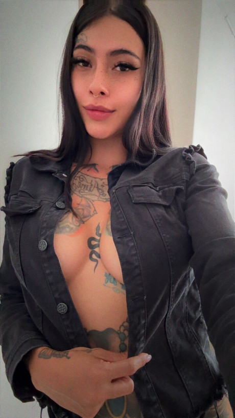 Brunette amateur shows her tattooed body while wearing a short denim skirt - #293898