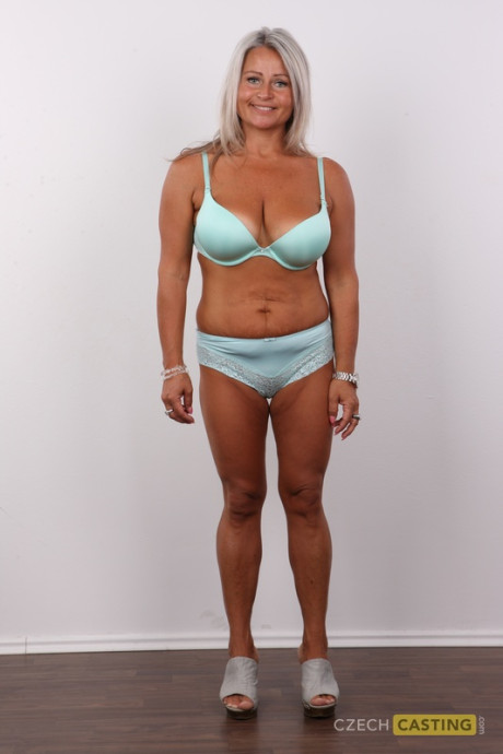Old blonde model stands straight and narrow before getting undressed on a stool - #277781