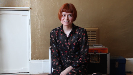 Skinny ginger head Enne toys her silky snatch while nude by a window in a solo - #324468