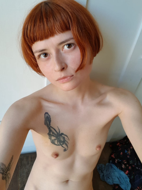 Skinny ginger head Enne toys her silky snatch while nude by a window in a solo - #324476