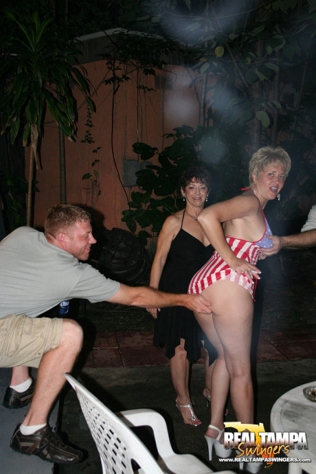 Playful amateur mature swinger wives teasing and French kissing at a party - #153896