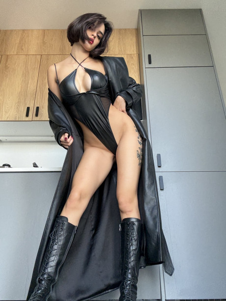Solo model with striking eyes shows her legs in a leather pantyhose ensemble - #309913