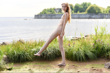 Skinny young babe Marika B posing ass naked on a enormous log in nature - #307757