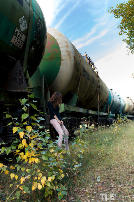 Thin young Rebeka Ruby squats on a rail car before pissing on the tracks - #306223