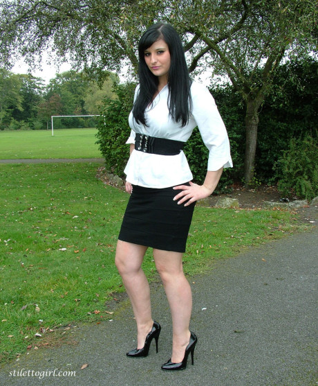 Clothed model Nicola poses on a park bench to show off her attractive legs #6462